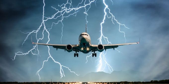 An aircraft is flying under the striking weather.