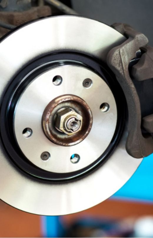 A brake pad is installed on the wheel of automotive.
